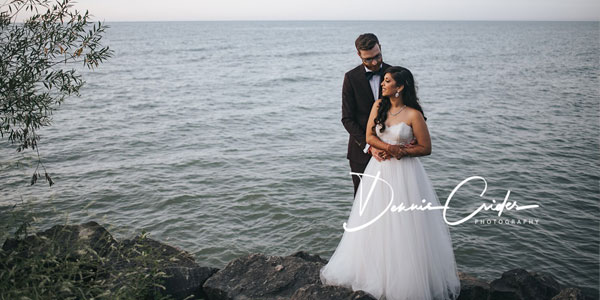 Bride and groom posing along the lake